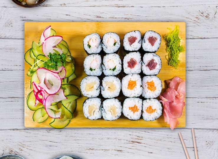 Delicious Sushi from ISO Sushi Wok & Grill, Wolverhampton Rectangular board with assorted sushi on, garnished with cucumber and radish