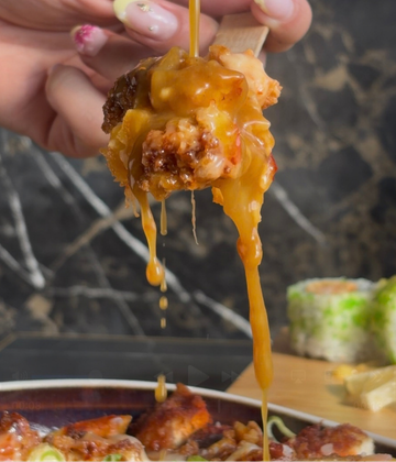 Katsu loaded fries dipped in katsu